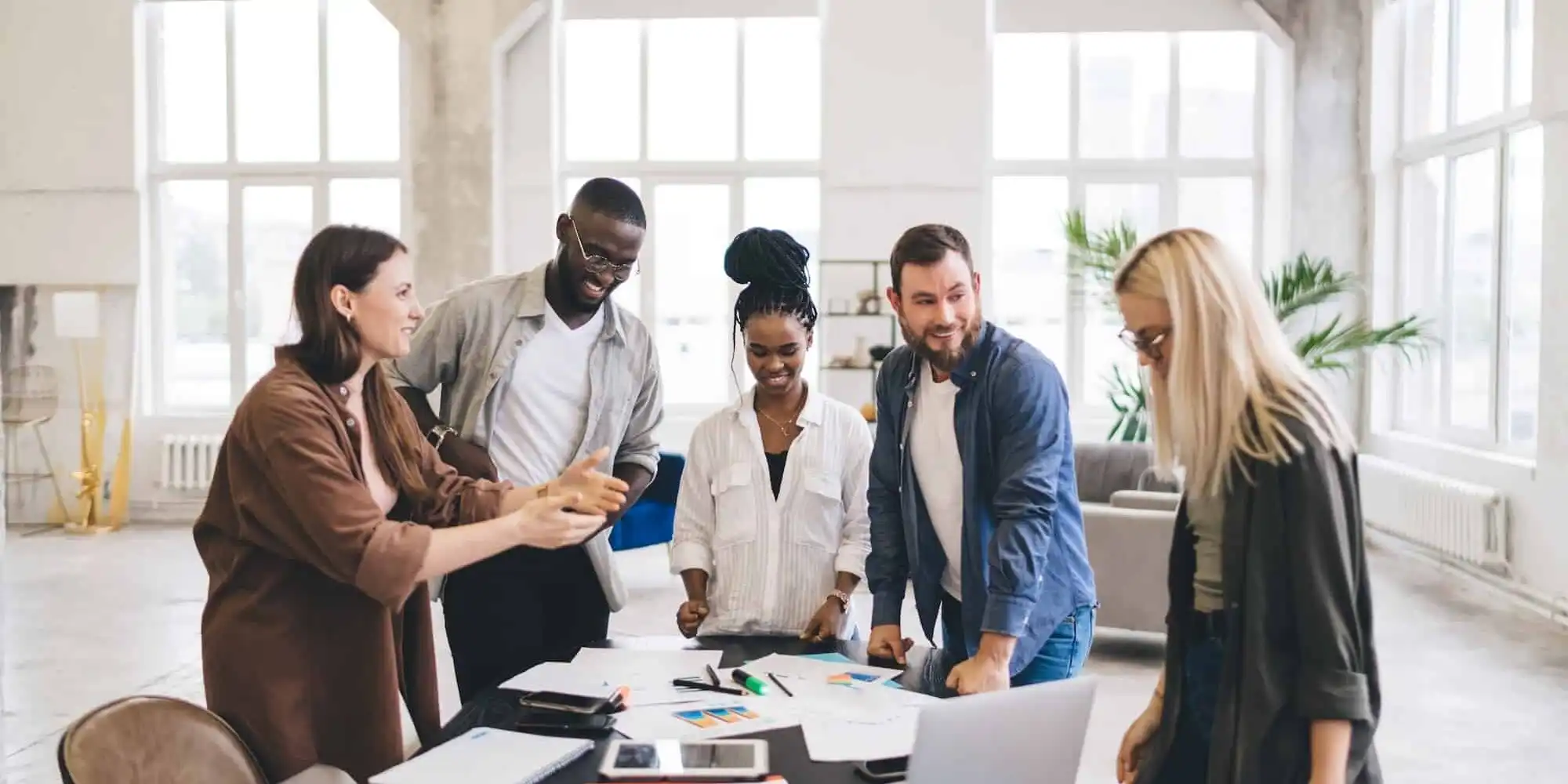 cheerful-colleagues-working-in-spacious-office-and-chatting