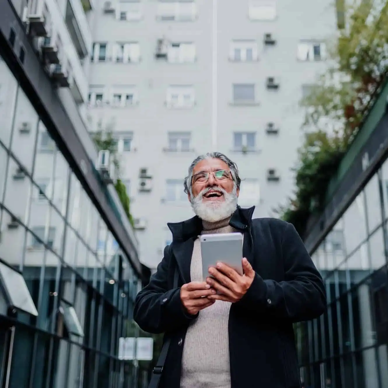 portrait-of-a-senior-businessman-using-tablet-outside-of-the-office-building-uai-1331x1331