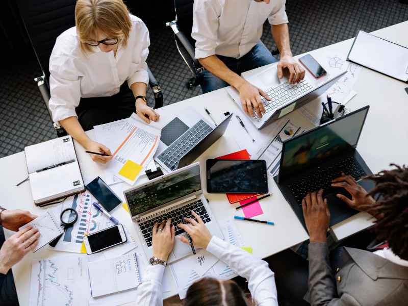 Professionals reviewing vendor-related operational documents in a modern property management office